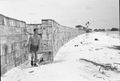 A wind break constructed from ration boxes protects the small RAF camp at Kelai, Maldive Islands, which serves as a refuelling base for flying boats operating in the Indian Ocean.