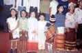 Tipra children in traditional attire grouping up for song presentation