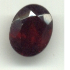 A cut and polished garnet gemstone, possibly of the almandine variety.