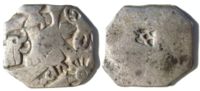 Silver punch mark coin of the Maurya empire, with symbols of wheel and elephant. 3rd century BCE.[بحاجة لمصدر]
