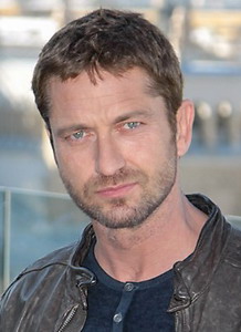 Headshot of Gerard Butler facing the camera with short brown hair and trimmed beard