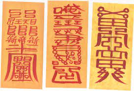 Three talismans, rectangles of paper marked with characters