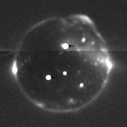 A LORRI image of Io, taken while New Horizons passed through its penumbra. Volcanic plumes, lava and aurora are all visible in this image.