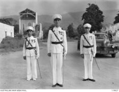 Portuguese governor Senhor Manuel Ferreira de Carvalho welcomes the Australians in 1945.