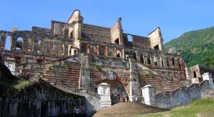 the tall, stone ruins of Sans-Souci Palace on a hilltop