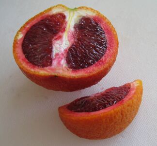 Anthocyanins produce the purple color in blood oranges.