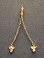 Gold ornament with two chains ending in owl figurines