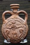 Terracotta pilgrim's Menas flask impressed with Saint Minas between two camels, Byzantine, 6th–7th century, probably made at Abu Mina, Egypt (متحف اللوڤر)