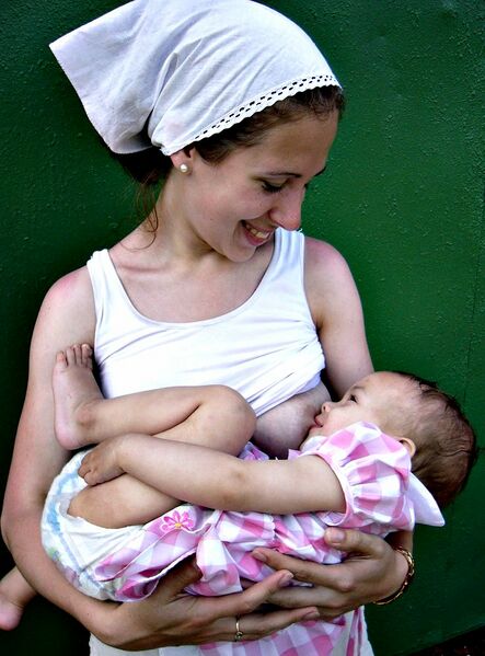 ملف:Woman breastfeeding an infant.jpg