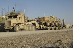 Oshkosh M1070A0 and DRS M1000 semi-trailer carrying a M93 Fox NBC detection vehicle