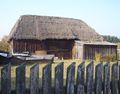 Board-on-board siding and a thatch roof on this three bay barn in Bartoszówka, Masovian Voivodeship, Poland.