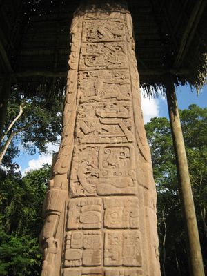 The side of a stela, divided into square panels containing sculpted heieroglyphs