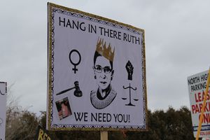 A poster with "hang in there we need you" written around Ginsburg's face and a crown on her head