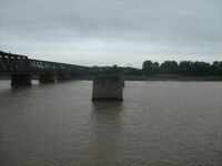 The pillar stubs of the Yalu River Broken Bridge between Dandong and Sinuiju, which was established in 1911 and destroyed during the Korean War. The bridge to the left is the Sino-Korean Friendship Bridge, which opened to traffic in 1943 and also fell to destruction by US aerial attacks during the war but was successfully repaired after 1953 (direction of photo looking south into North Korea).