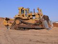 The Caterpillar D10N bulldozer evolved from tracked-type tractors and is characterized by a steel blade attached to the front that is used to push other equipment and construction materials, such as, earth.