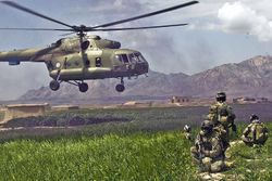 ISAF forces pull security for the safety of the pilots and team of an Mil Mi-17 helicopter as it leaves the Gulistan district in 2009.