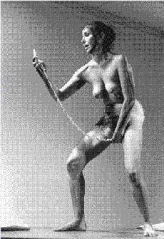 Carolee Schneemann, performing her piece Interior Scroll, 1975.