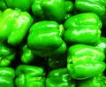 Green Bell Peppers on display at a Grocery Store