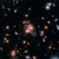 Galaxy cluster SpARCS1049 taken by Spitzer and the Hubble Space Telescope.[6]