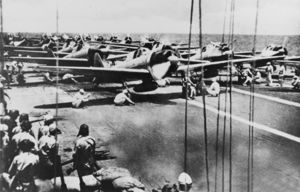 Aircraft lined up on the deck of an aircraft carrier