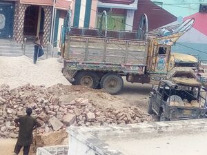A Kekra truck unloading construction material in Islamkot