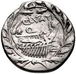 An ancient coin depicting a galley surrounded by a wreath of oak leaves