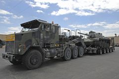 Oshkosh M1070A0 HET and DRS M1000 semi-trailer hauling an M60 Patton tank