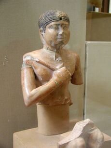Bust and head of a pharaoh holding a flail.