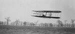 A historic photograph depicting one of the early flights of Wright brothers