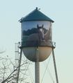 The water tower consists of a cone, a cylinder, and a hemisphere. Its volume can be calculated using solid geometry.