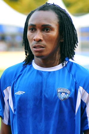 Photo of a player in blue football kit, hair braided.