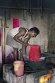 A man dyeing a silk sari red in boiling water in Kumbakonam, Tamil Nadu