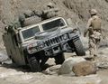 A U.S. Marine Corps High Mobility Multipurpose Wheeled Vehicle traversing difficult terrain in Khost Province, Afghanistan