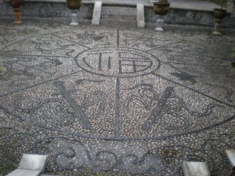 A pebble mosaic in a small inner courtyard of the Mu Mansion, Old Town of Lijiang, Yunnan, with Fu character in the center