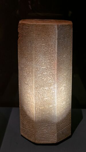 A six-sided stone prism with text carved into its faces