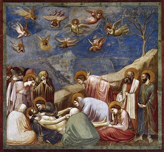 Square fresco. In a shallow space like a stage set, lifelike figures gather around the dead body of Jesus. All are mourning. Mary Magdalene weeps over his feet. وحواري يُلقي بذراعيه يأساً. Joseph of Arimethea holds the shroud. في الفردوس، ملائكة صغار are shrieking and tearing their hair.