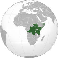 An orthographic map projection of the world, highlighting the East African Community's member states (green) and applicants (light green)