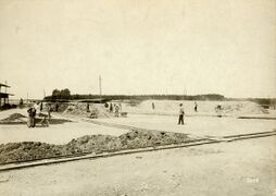 1900ح. 1900–1910 a drying area: One firing pile is being prepared; another is under way.