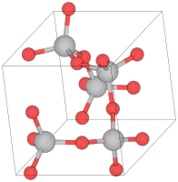 Unit cell of α-cristobalite; red spheres are oxygen atoms. We see here five silicon atoms in a helix (the first and the last are equivalent atoms in the lattice) going in the "c" direction (into the page). The horizontal and vertical axes are the "a" axes.