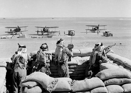 Arb Legionnaires guard the landing ground at H4 pumping station on the IPC pipeline in Transjordan, as Gloster Gladiators of No. 94 Squadron RAF Detachment refuel during their journey from Ismailia Egypt.