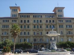 A view of one of Viareggio's many grand hotels along the famous passeggiata, with the "Fountain of the Four Seasons" by Beppe Domenici in front.