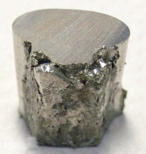 A pitted and lumpy piece of nickel, with the top surface cut flat