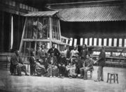 Directors of the exposition, before the golden shachi in the Taiseiden courtyard (1872)