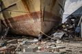 A boy stands in front of a stranded ship in Donggala on October 2.jpg