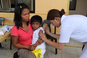 Providing vaccinations to protect against disease after Typhoon Haiyan (11352296333).jpg