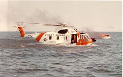 HH-3F Pelican on the water with a burning boat.jpg