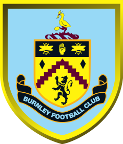A shield-shaped crest with a mainly light blue background. The crest features a stork at the top, standing on hills and cotton plants. Further down, a black band including a hand and two bees; a wavy, claret-coloured line, and a lion. "Burnley Football Club" is written at the bottom.