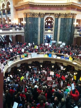 Overhead view of hundreds of people wearing red for the Teacher's union, protesting against Walker's bill.