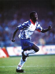 Napoli, stadio San Paolo, 21 ottobre 1992. L'attaccante liberiano George Weah esulta dopo uno dei suoi due gol che decisero la sfida tra e (0-2) valevole per l'andata dei sedicesimi di finale della Coppa UEFA 1992–1993.