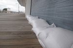 Sand bags line the front of an arcade on the boardwalk in Point Pleasant Beach New Jersey earlier today.